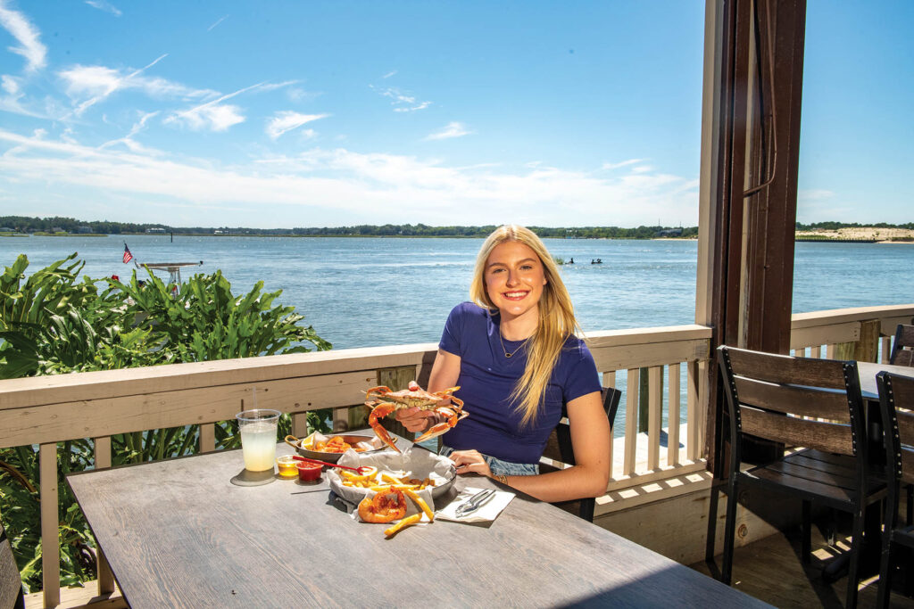 girl eating lunch with water view