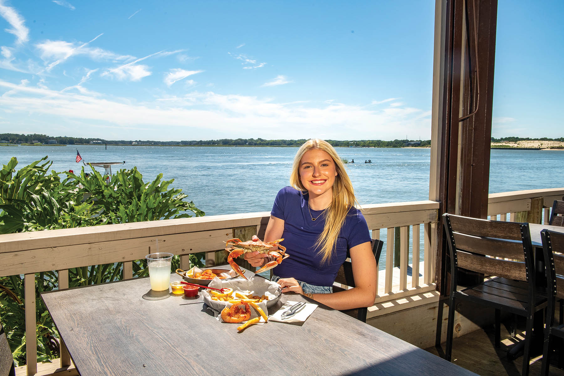 girl eating lunch with water view